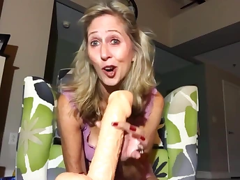 Chirpy blonde is holding a huge dildo ready to fuck pussy hole